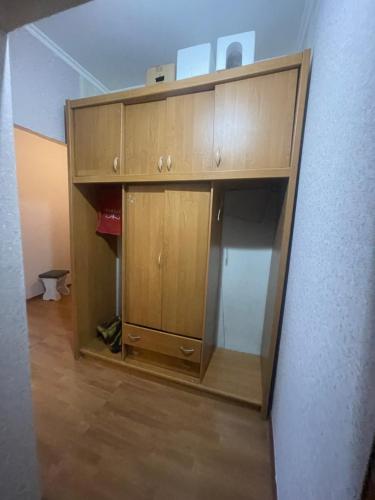 a wooden cabinet in the corner of a room at Самал3 in Almaty
