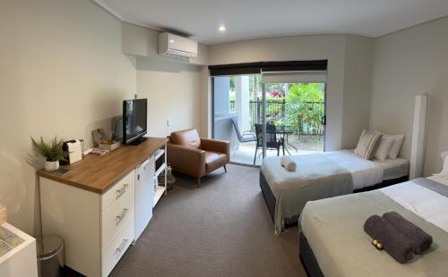 a hotel room with two beds and a television at Cosy Hotel Room with plunge pool at Kingscliff Salt Beach Resort and Spa in Kingscliff