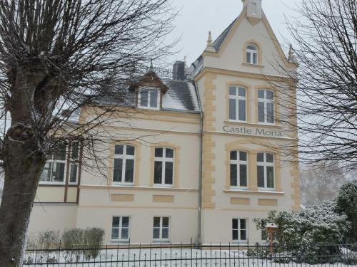 a large yellow and white building with a clock tower at Castle Mona Diestel GM 69176 in Graal