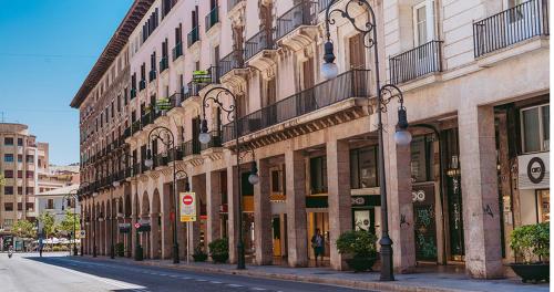 a city street with a row of tall buildings at Jaime III - Palma center - Luxury Suites in Palma de Mallorca