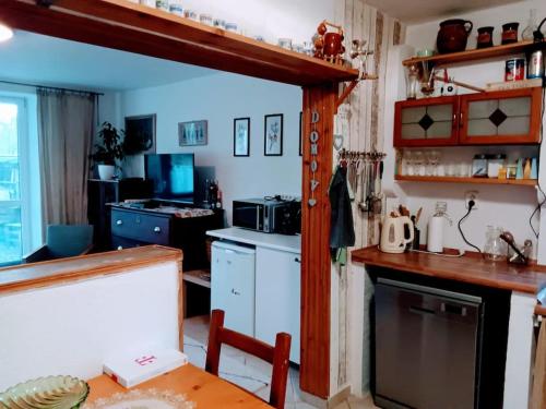 a kitchen with a table and a counter top at Tradičná kopaničiarska chalupa in Košariská-Priepasné