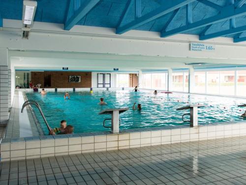 a large indoor swimming pool with people in it at 4 person holiday home on a holiday park in Lemvig in Lemvig