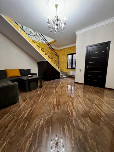 a living room with a staircase and a couch at New , comfortable 3 bedroom house in Yerevan
