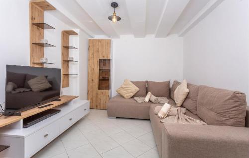 a living room with a couch and a tv at Lovely Home In Rijeka With Wifi in Rijeka