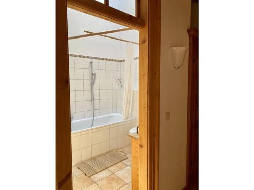 a bathroom with a shower and a bath tub at Tateful apartment in Schliersee in Schliersee