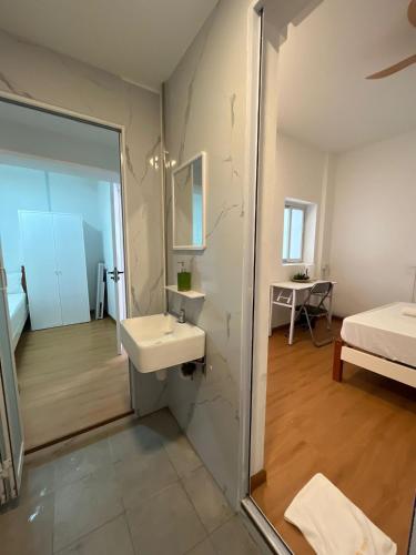 a bathroom with a sink and a mirror at Duke Living in Singapore