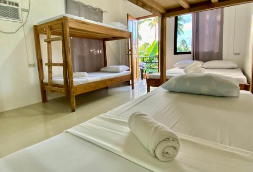 a room with four bunk beds in a room at RedDot Guest House in General Luna