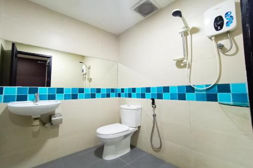 a bathroom with a shower and a toilet and a sink at OYO 90091 Hi Inn in Sibu