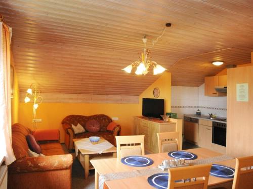 a kitchen and living room with a table and chairs at Holiday apartment Sonnenfels II in Bodenmais