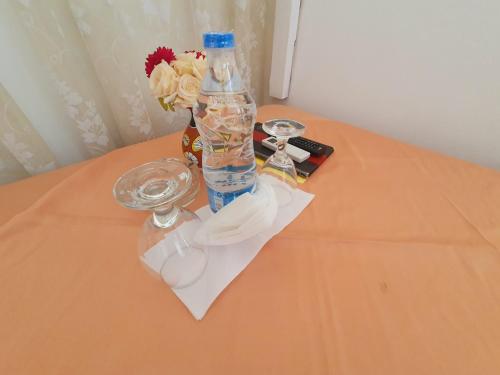 a bottle of water sitting on top of a table at Kolonne RIverside Garden Hotel in Avissawella