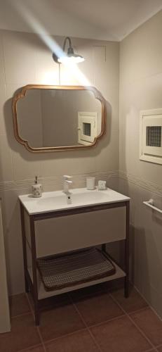 a bathroom with a sink and a mirror at Ca La Silvia Masboquera in Mas Boquera
