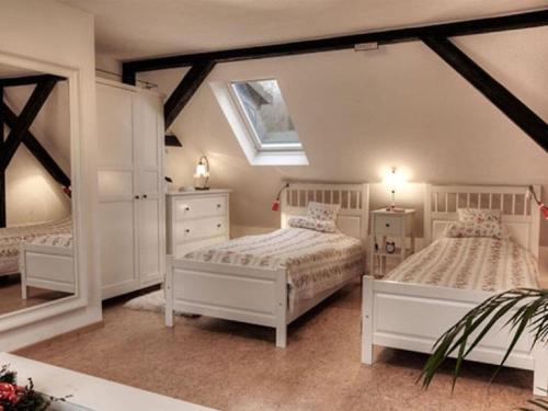 a bedroom with two beds and a window at Cosy apartment in Harz in Schauenburg