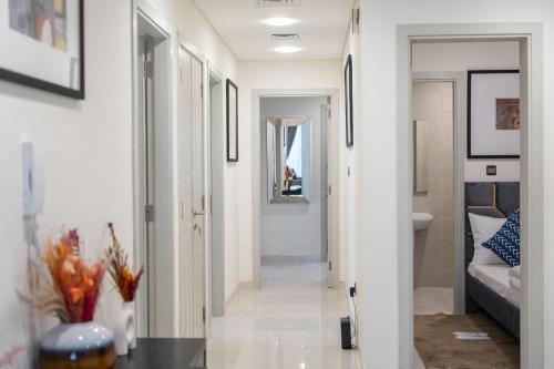 a hallway leading to a bathroom with a toilet at Trinity Holiday Homes - Polo Residences Meydan in Dubai