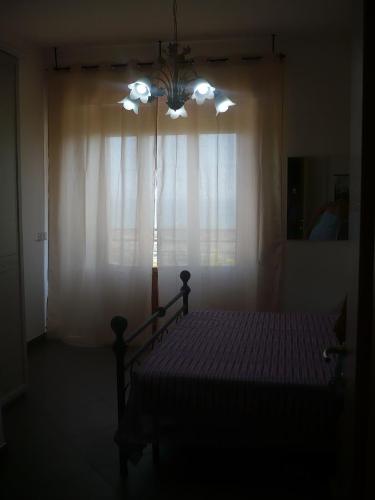 a bedroom with a bed and a window with curtains at Terrazza sul Mare in Giulianova