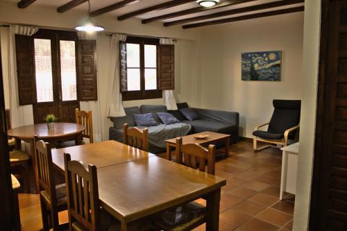 a living room with a couch and a table and chairs at Castillo con piscina en plena Sierra Calderona in Segorbe