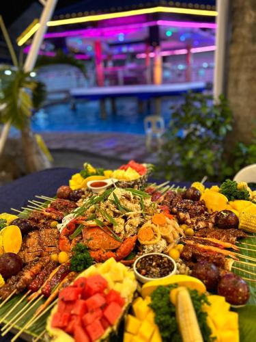 a plate of food with meat and vegetables on a table at Clark CU Hotel in Angeles