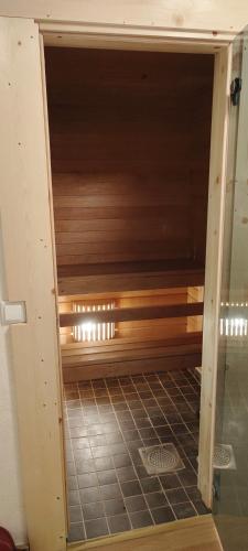 porta entreaberta de um quarto com uma parede de madeira em Kesklinnas keldrikorrusel asuv saunaga korter em Tartu
