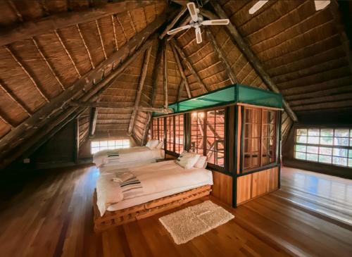 a large room with a bed in a attic at Limpokwena Nature Reserve in Tokio