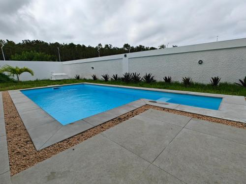 a swimming pool in front of a building at Villa Sakura in Poste Lafayette