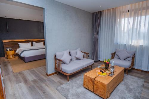 a hotel room with a bed and a living room at Hotel Barahi Kathmandu in Kathmandu