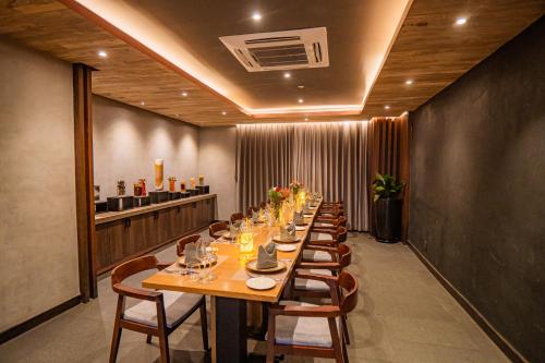 a long dining room with a long table and chairs at Hotel Barahi Kathmandu in Kathmandu