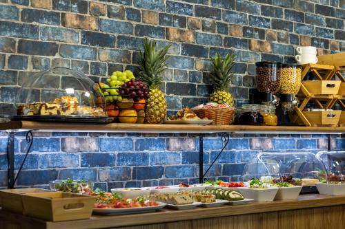 a buffet with a variety of fruits and vegetables at Hotel A4 Wrocław - Bielany in Bielany Wrocławskie