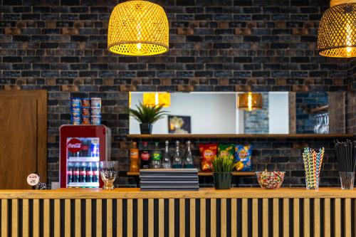 a bar with lights on a brick wall at Hotel A4 Wrocław - Bielany in Bielany Wrocławskie