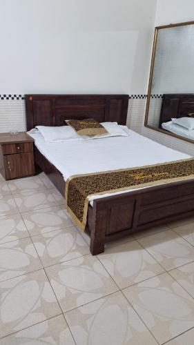 a large bed in a room with a large mirror at Hương Giang Hotel & Coffee in Thái Bình