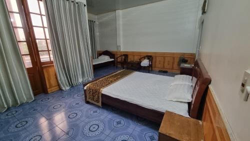 a hotel room with a bed and a window at Hương Giang Hotel & Coffee in Thái Bình