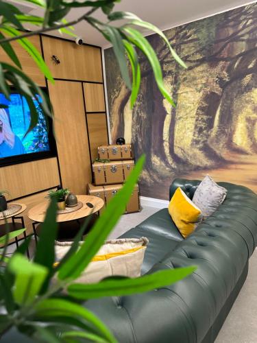 a living room with a couch and a tv at HOTEL LOTUS in Caldas de Reis