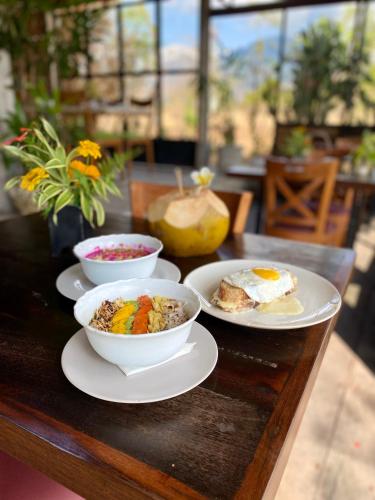 a table with three bowls of food on it at Sumberkima Hill 2 in Pemuteran