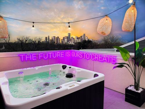 a bath tub with a sign that reads the future is ours to create at Paradise Palace Best Rooftop in HTX w Hot Tub in Houston