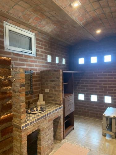 a bathroom with a brick wall and a sink at Baja69 lodge in El Pescadero