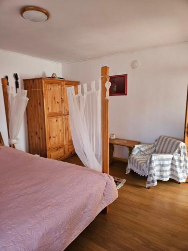 Un dormitorio con 2 camas y una silla. en Guest house Kashtata, en Shabla