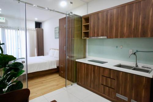 a bathroom with a sink and a shower with a bed at Cityhouse - Nguyễn Đình Chiểu in Ho Chi Minh City
