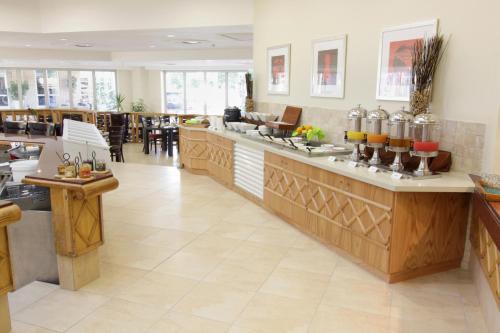 a restaurant with a bar with some drinks on it at Cresta Lodge Gaborone in Gaborone