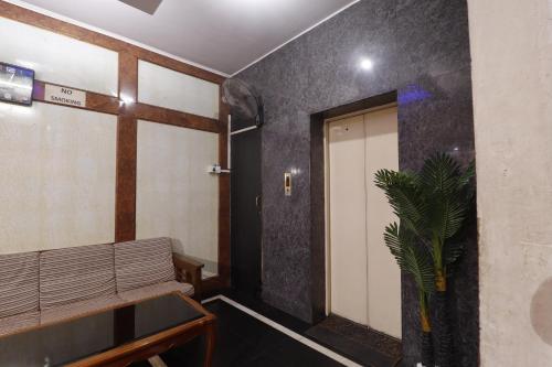 a hallway with a door and a bench and a plant at The Royal Comfort in Bangalore