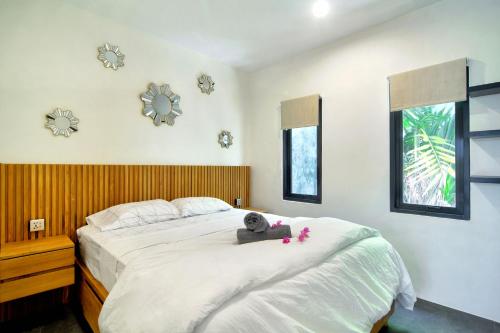 a bedroom with a bed with a teddy bear on it at La Casa Deluxe - short escape from pererenan beach in Munggu