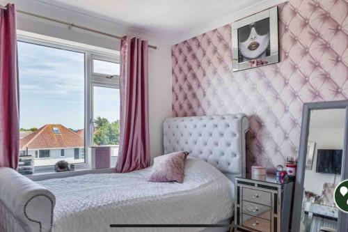 a bedroom with a bed and a large window at 22 rooftop Penthouse ! in South Hayling