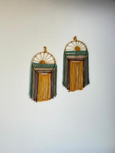 a pair of earrings with tassels on a white background at Vile Villa Homestay View Biển 01 Đảo Phú Quý in Cu Lao Thu