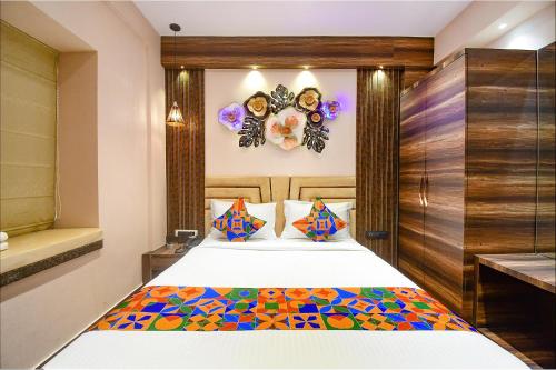 a bedroom with a bed with a colorful blanket at FabHotel Prime Jalsa in Kolkata
