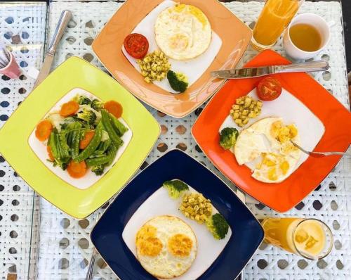 a table topped with plates of food and drinks at Binh An Village Resort in Da Lat