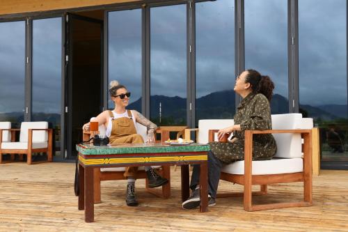 two women sitting at a table on a patio at Yeruu lodge in Jargalant