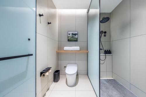 a small bathroom with a toilet and a shower at Atour X Hotel Nanjing Jiangning Future Internet Town in Jiangning