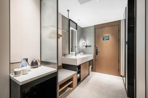 a bathroom with a sink and a mirror at Atour Hotel Chengdu Jinhua Wanda Liulichang in Chengdu