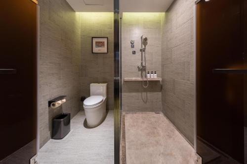 a bathroom with a toilet and a shower at Atour Hotel Zhongshan North Station V-PARK Plaza in Zhongshan