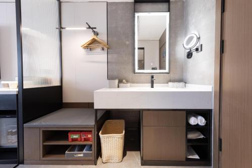 a bathroom with a sink and a mirror at Atour Hotel Guangzhou Baiyun Jiahe Hebian in Guangzhou