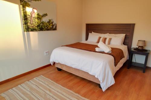 A bed or beds in a room at Imvubu Lodge - Zulweni Private Game Reserve