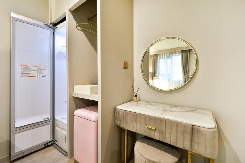 a bathroom with a sink and a mirror at Denbasta Hotel Daeyeon in Busan