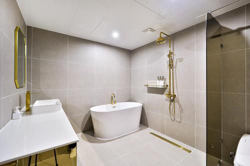 a bathroom with a toilet and a sink and a shower at Denbasta Hotel Daeyeon in Busan